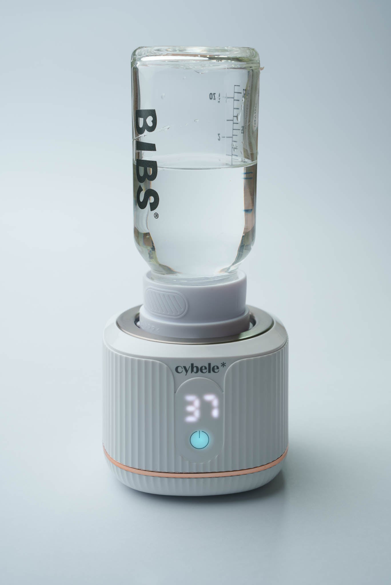 Stellar Portable Baby Bottle Warmer connected to a BIBS baby bottle via an adapter, warming breast milk, formula, or water.