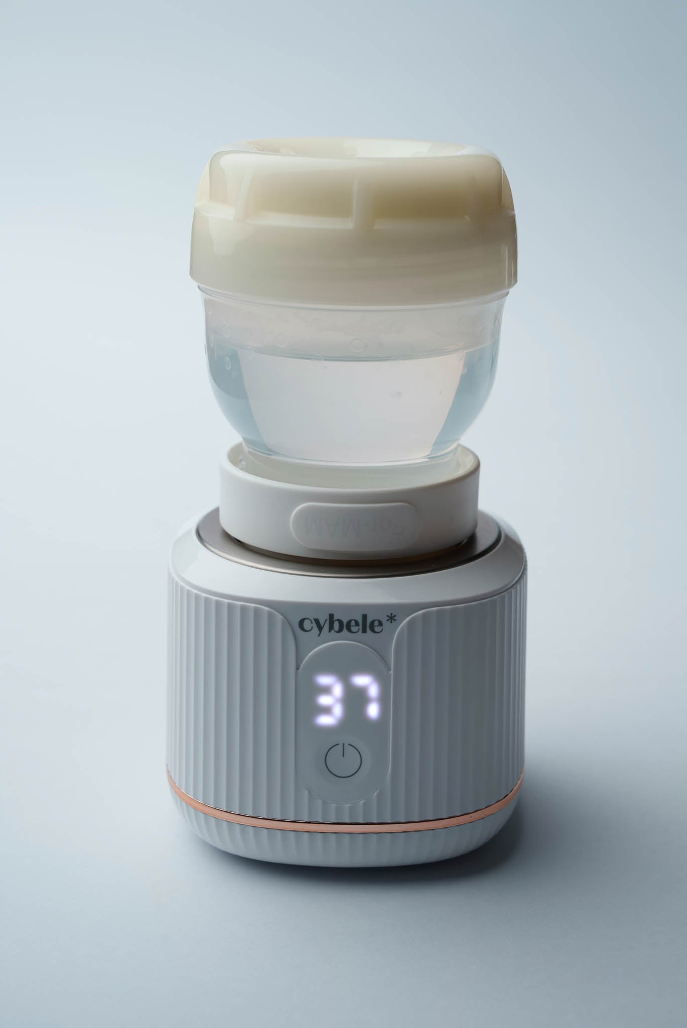 Stellar Portable Baby Bottle Warmer connected to a MAM baby bottle via an adapter, warming breast milk, formula, or water.