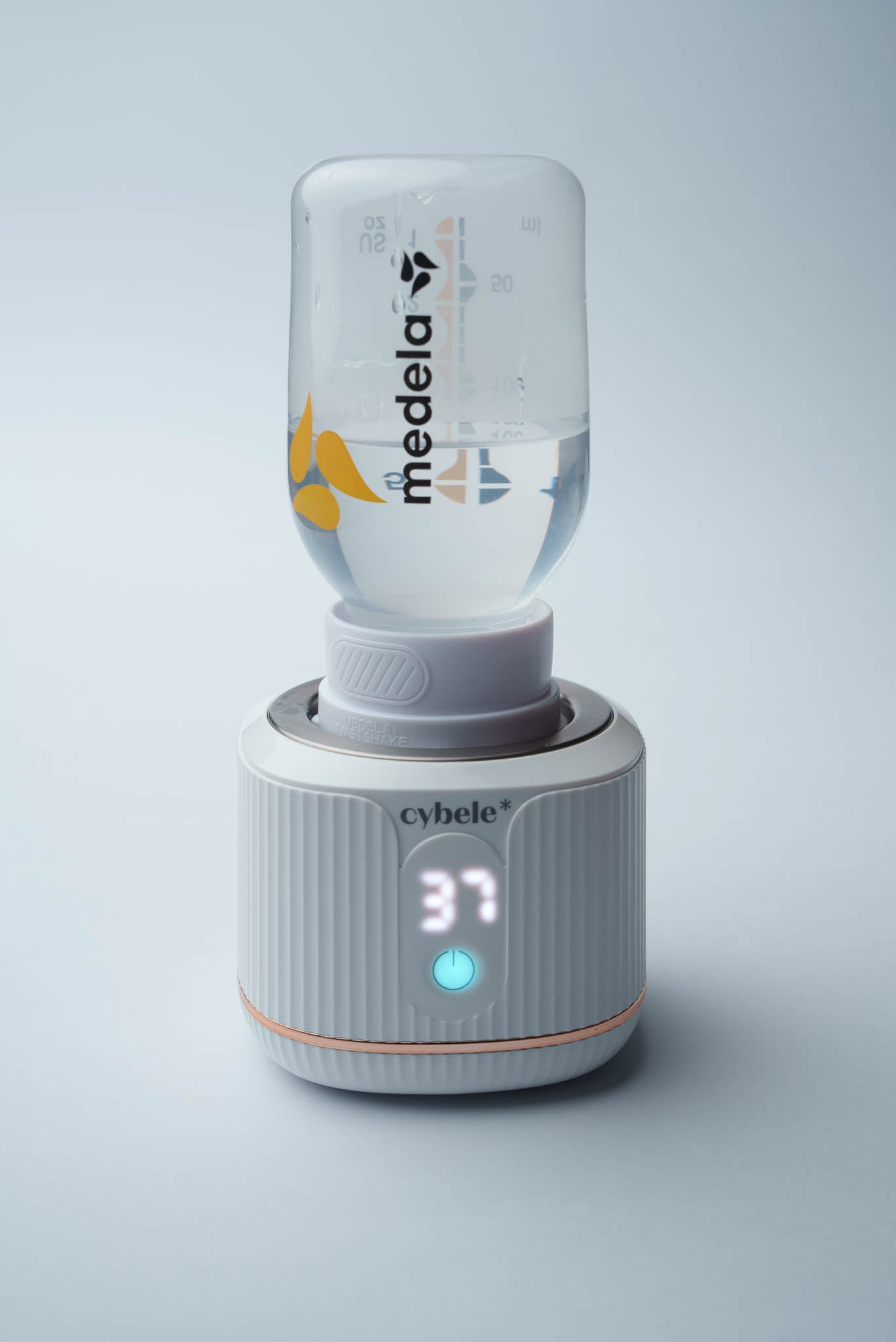 Stellar Portable Baby Bottle Warmer connected to a Medela bottle via an adapter, warming breast milk, formula, or water.