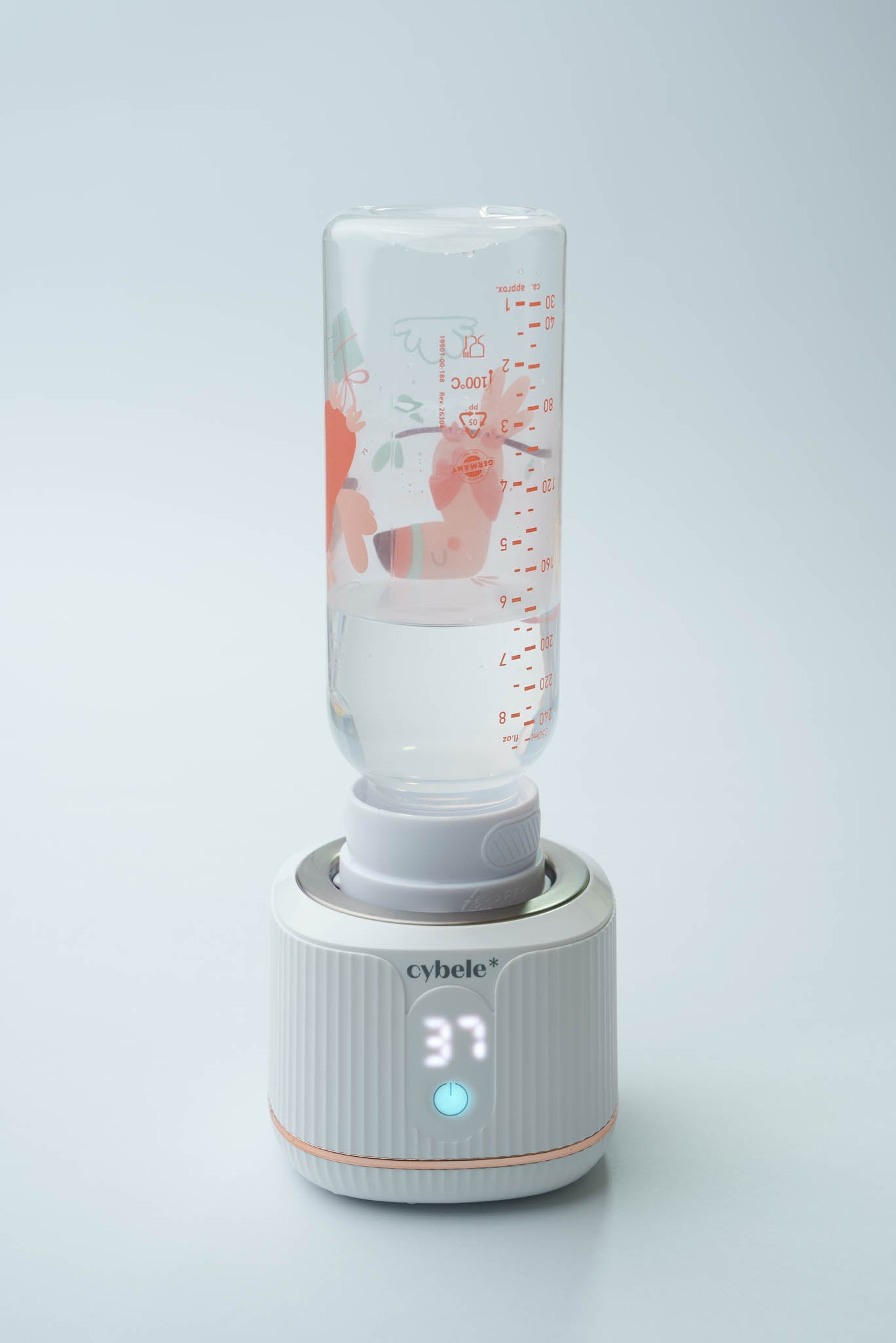 Stellar Portable Baby Bottle Warmer connected to a NIP narrow neck baby bottle via an adapter, warming breast milk, formula, or water.