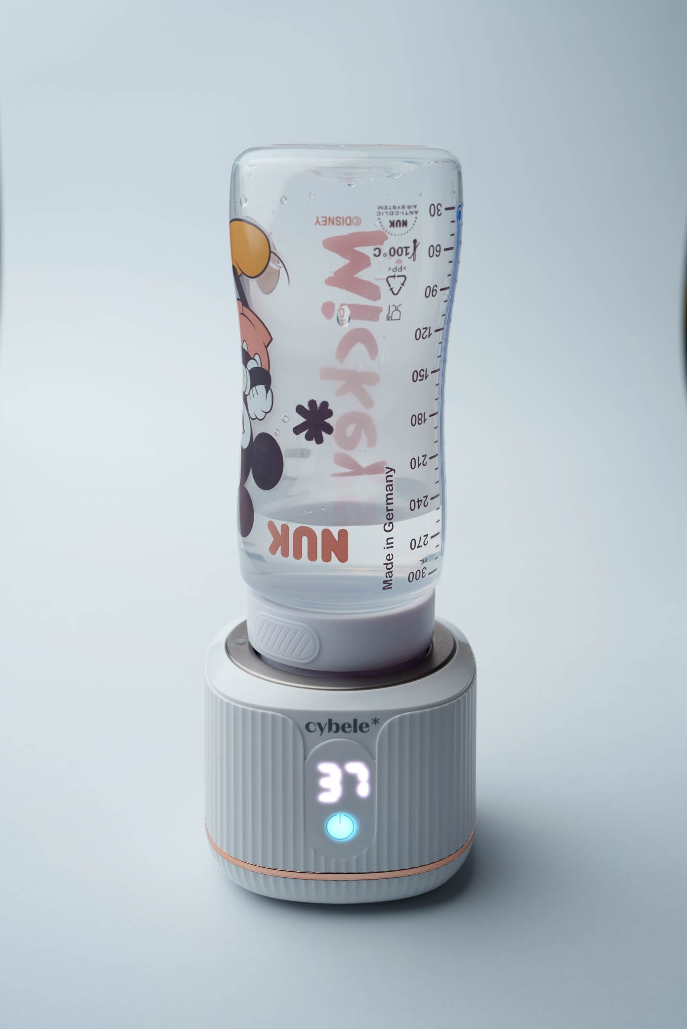 Stellar Portable Baby Bottle Warmer connected to a NUK First Choice baby bottle via an adapter, warming breast milk, formula, or water.