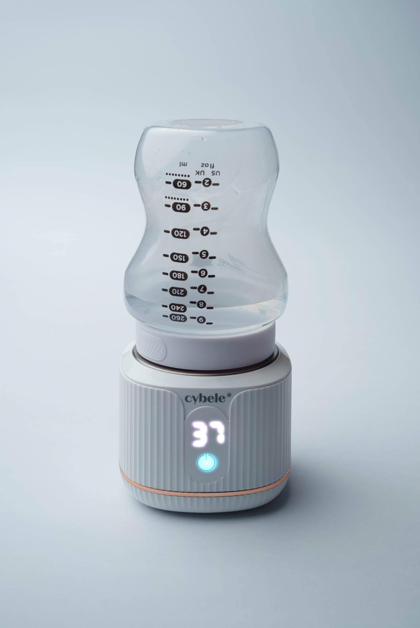 Stellar Portable Baby Bottle Warmer connected to a Tommee Tippee baby bottle via an adapter, warming breast milk, formula, or water.