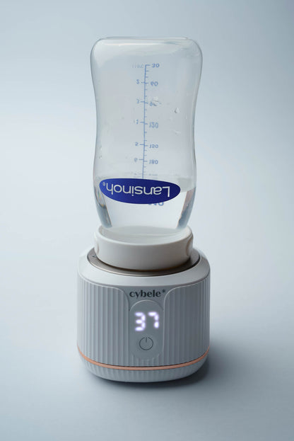 Stellar Portable Baby Bottle Warmer connected to a Lansinoh baby bottle via an adapter, warming breast milk, formula, or water.