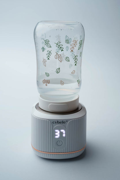 Stellar Portable Baby Bottle Warmer connected to a NIP wide neck baby bottle via an adapter, warming breast milk, formula, or water.